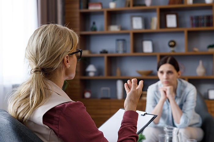 A woman participates in addiction counseling.