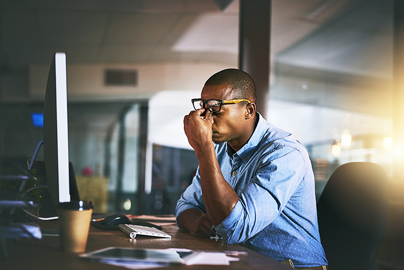 A man struggles with work-related stress.