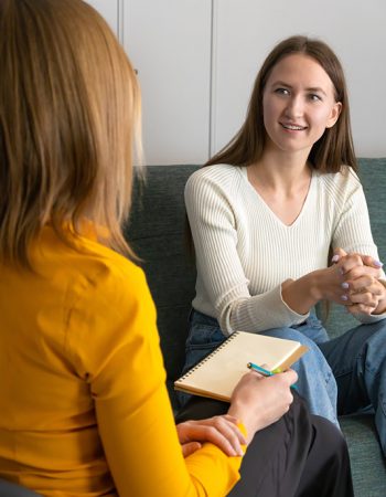 A woman participates in therapy at a drug rehab.